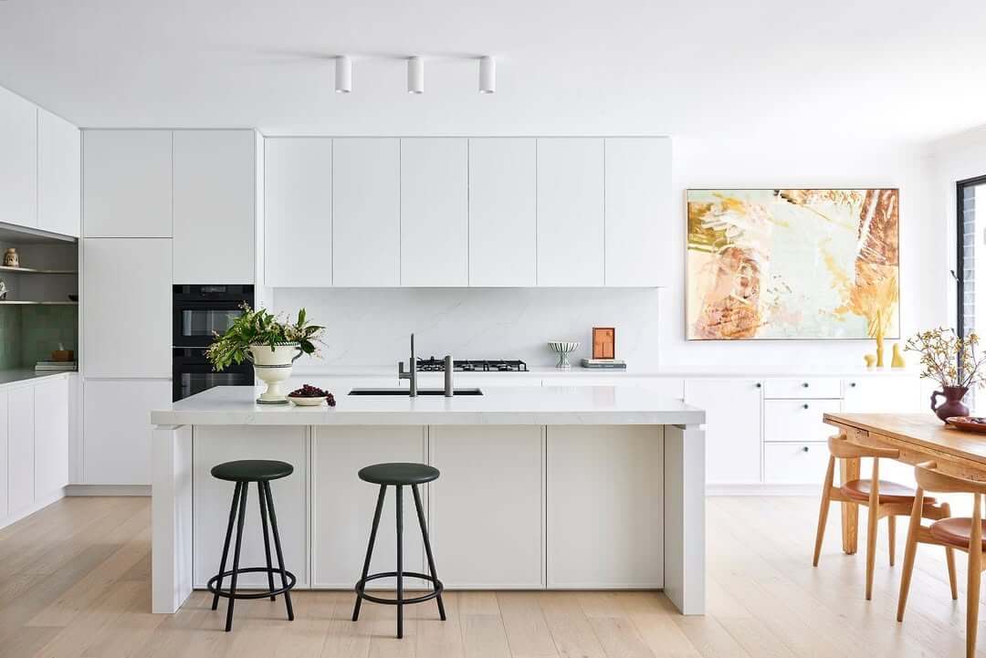 Abstract Art Adds Warm Color to All-White Kitchen