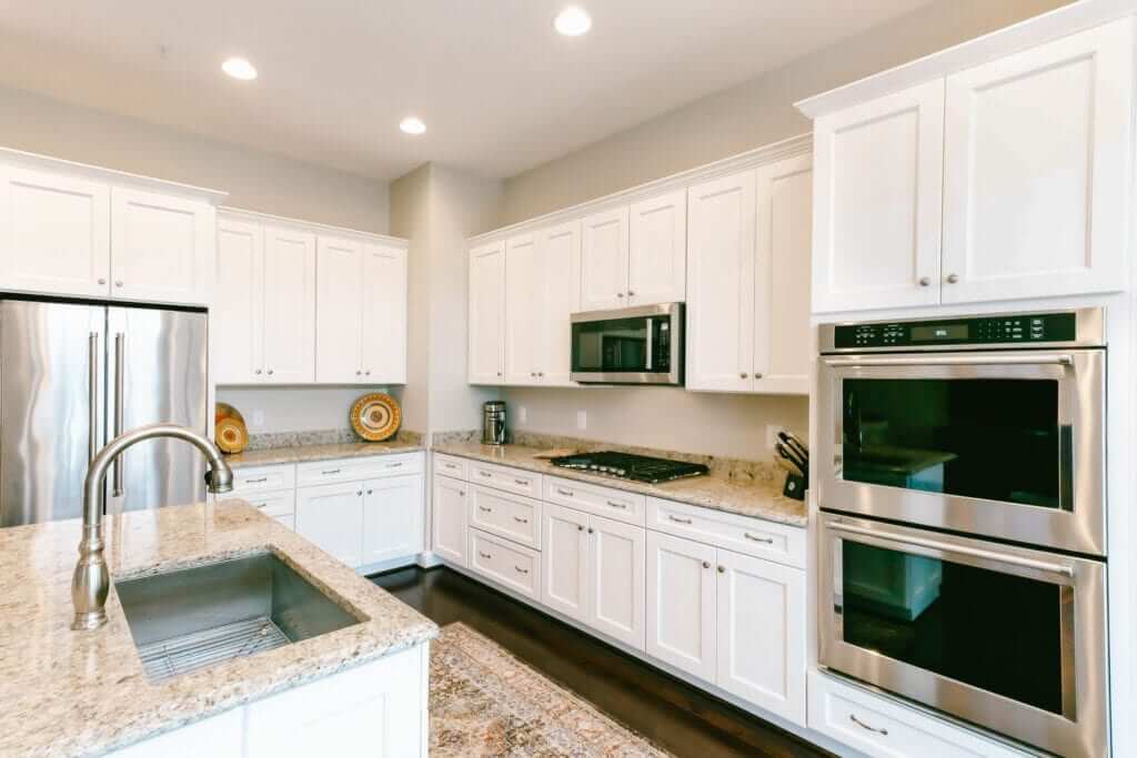 Stacked Double Ovens Integrate Sleekly Into White Cabinetry