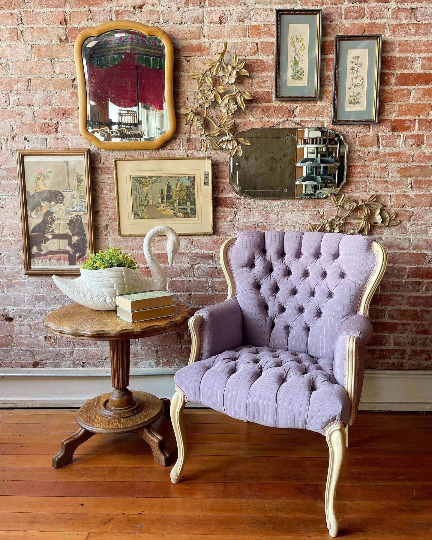 Layered Vintage Art and Mirrors for an Eclectic Brick Wall