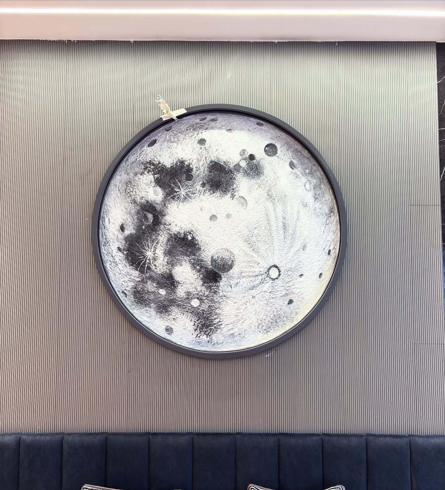 Circular Moon Artwork With Perched Rocket Accent