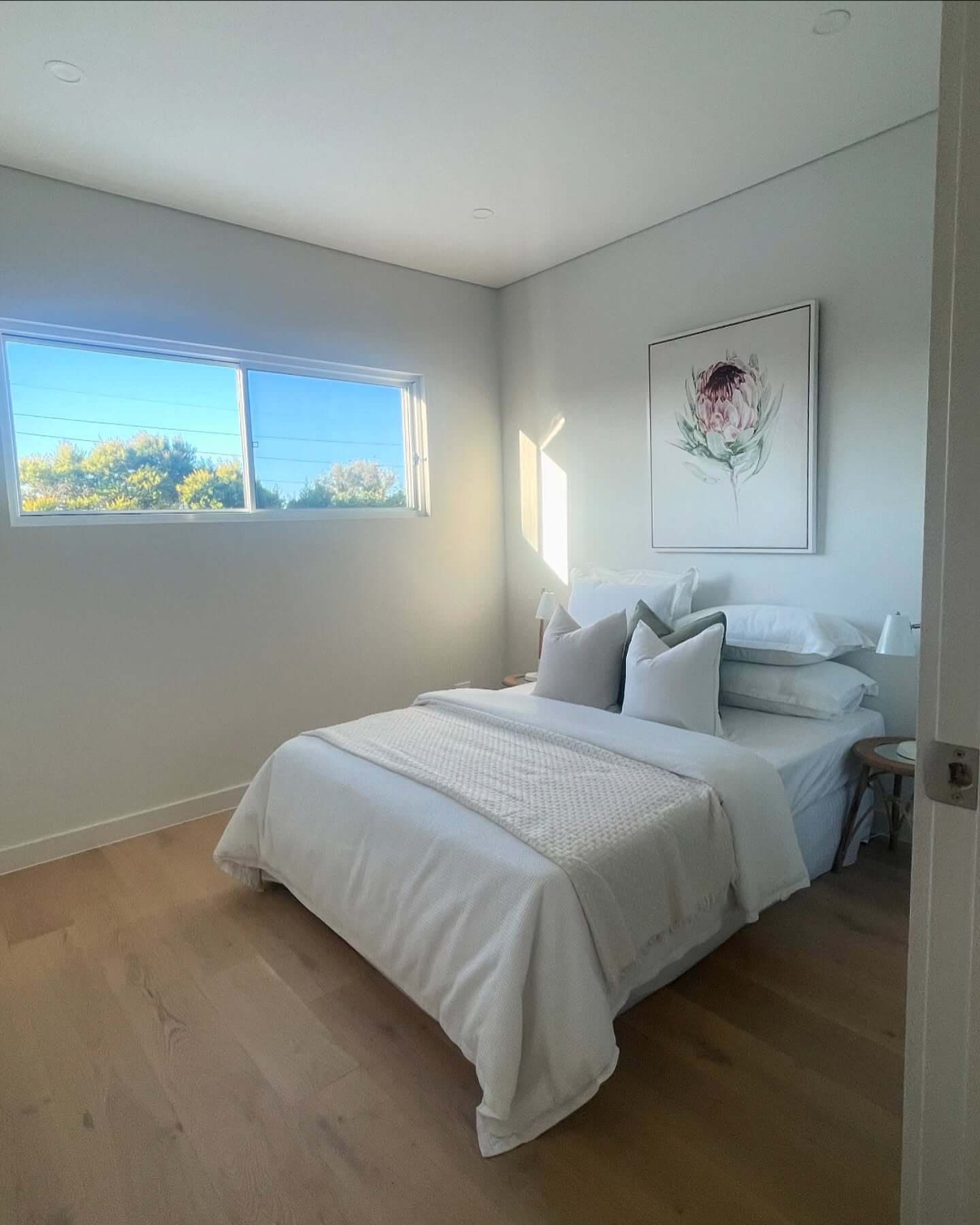Introduce Soft Color with Botanical Art in a Neutral Bedroom