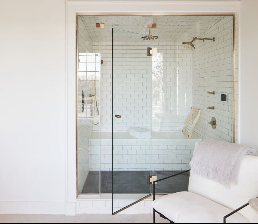 White Subway Tile Shower with Built-In Bench and Gold Fixtures