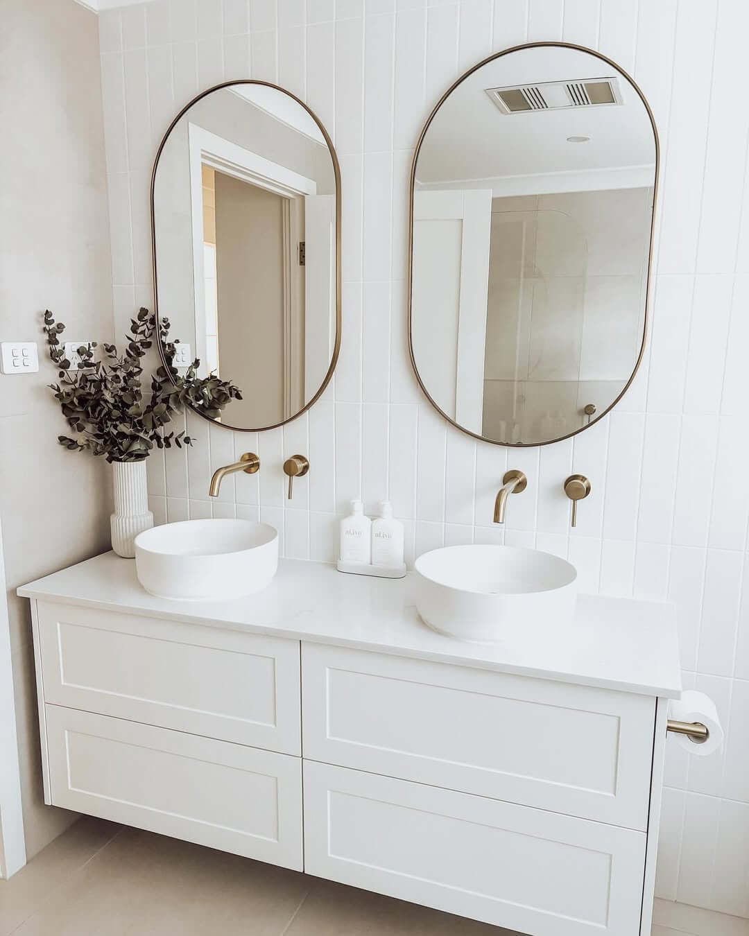 Rounded Edge Mirrors Frame Dual Vessel Sinks With Gold Faucets