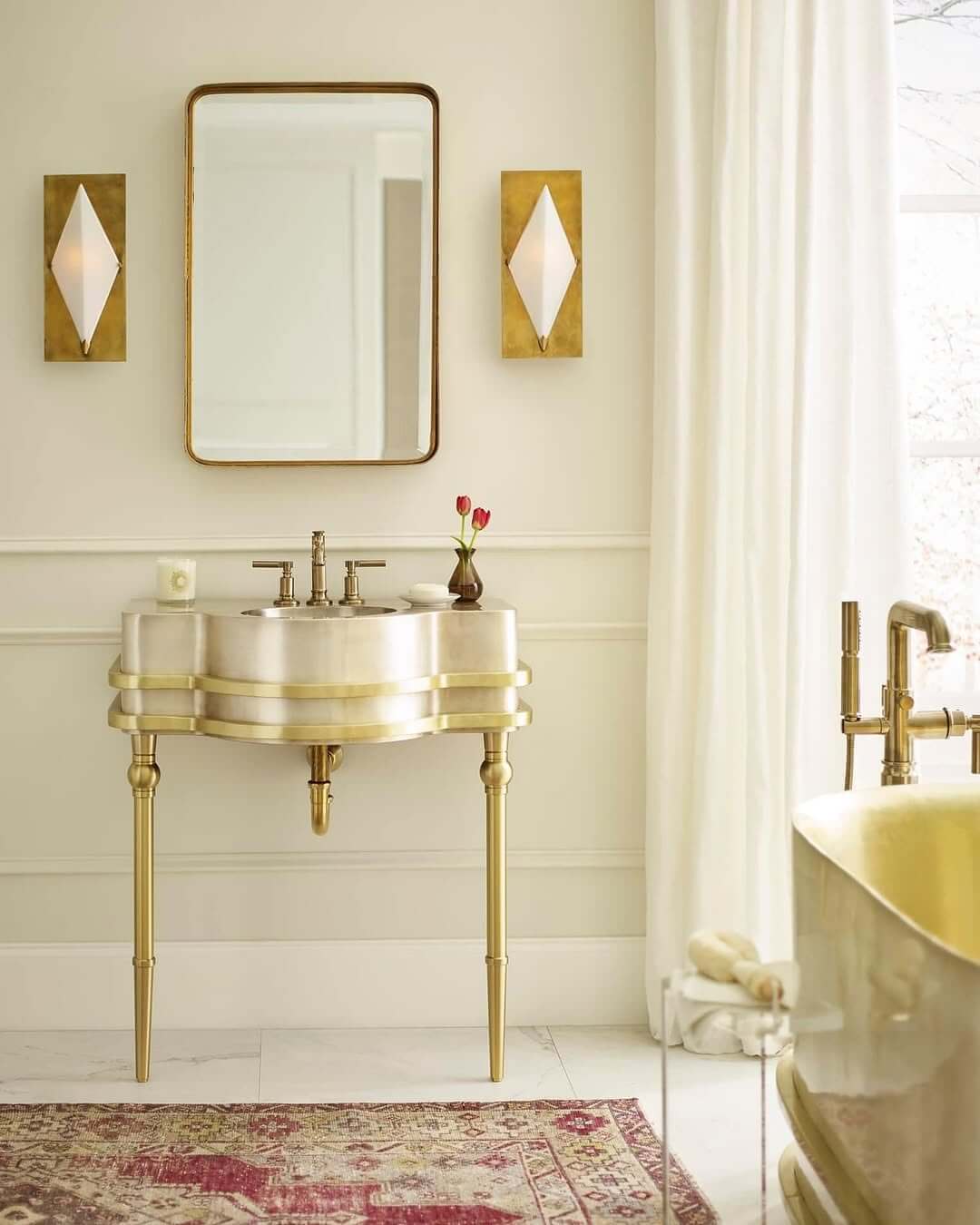 Gold Pedestal Sink Base Adds Glamour to White Bathroom