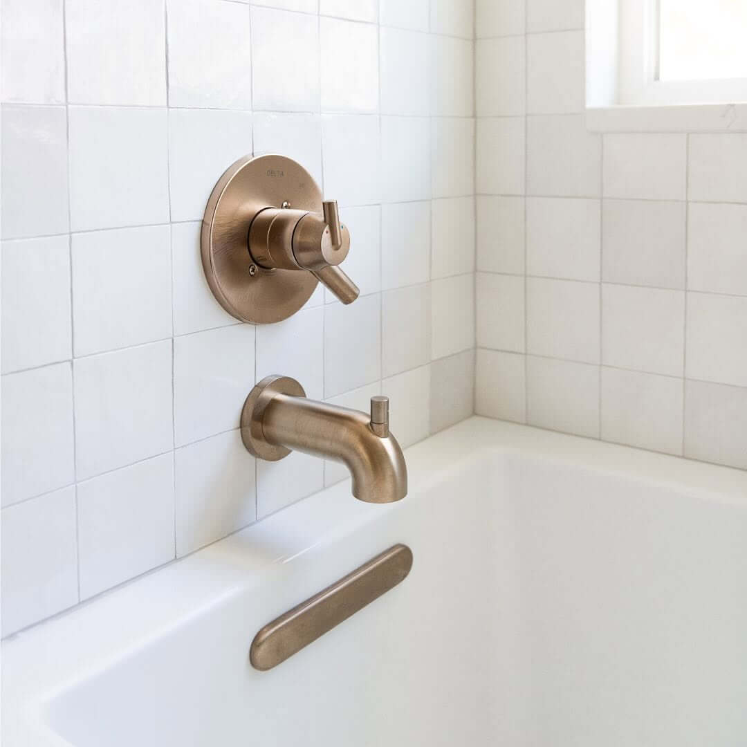 Rounded Gold Tub Spout and Controls Add Warmth