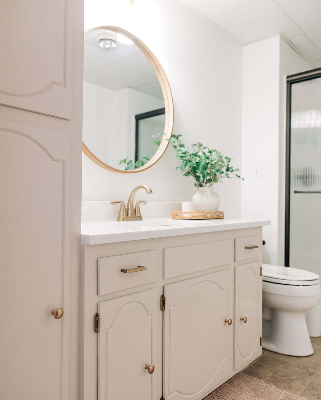 Gold Faucet and Drawer Pulls Complement Cream Vanity