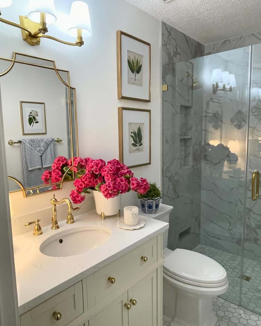 Botanical Prints Frame a White Vanity with Gold Accents