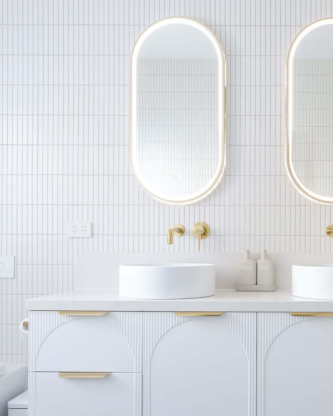 Arched Cabinet Doors Add Softness to White Vanities