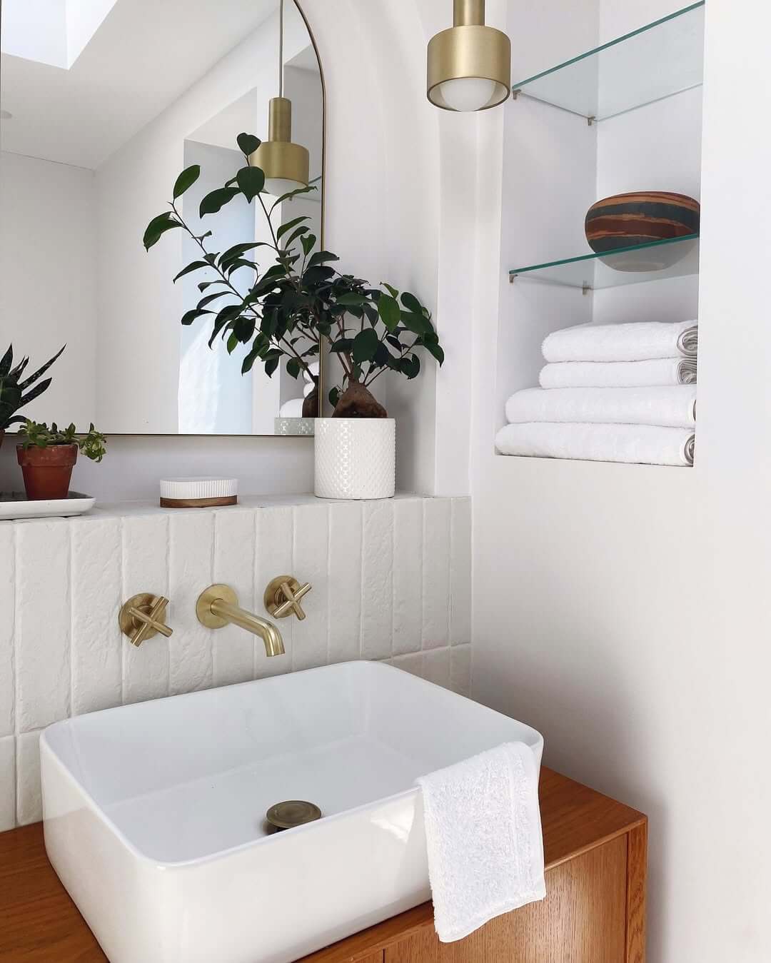 Brass Cross-Handle Faucets Add Warmth to White Tile